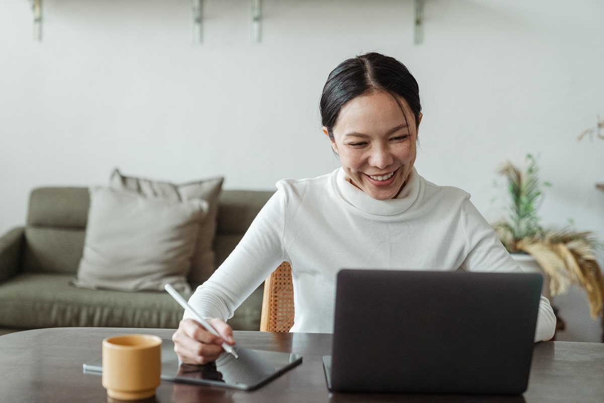 Woman looking at laptop and smiling 
